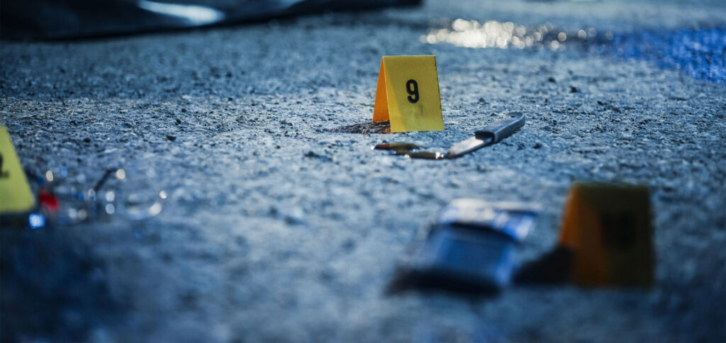 A police evidence marker of a bloody knife on a street