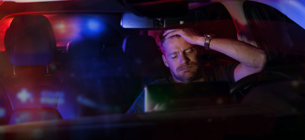 Man being detained by the police after an traffic stop