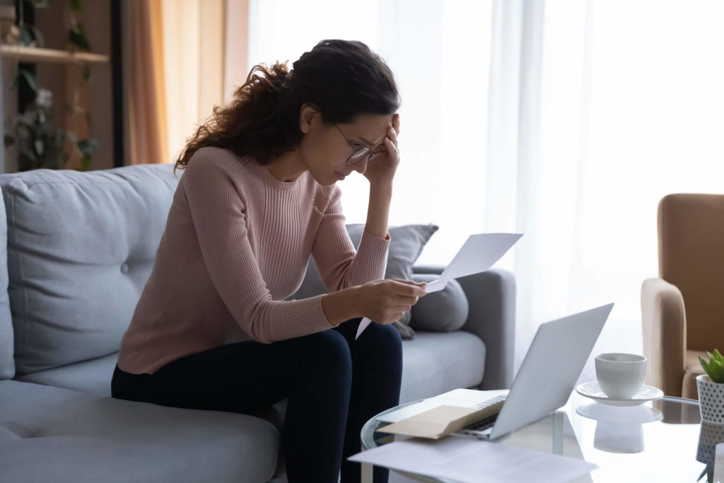 Woman reads employment rejection letter