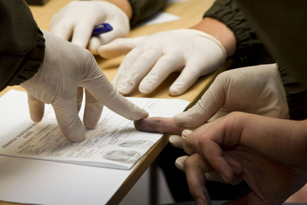 Person being fingerprinted during the criminal booking process 