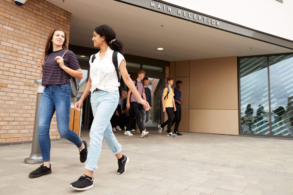 High school students walking outside high school building