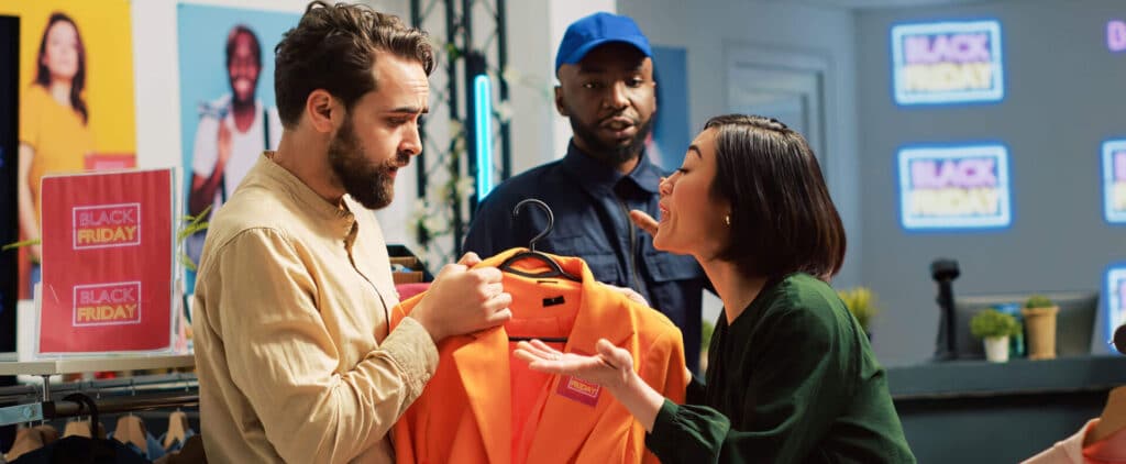 Store security guard and loss prevention store employee approach a suspected shoplifter