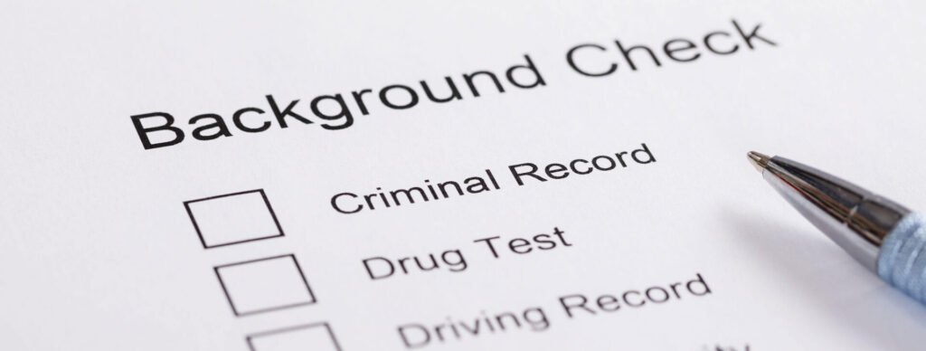 Person filling out job application with criminal record check