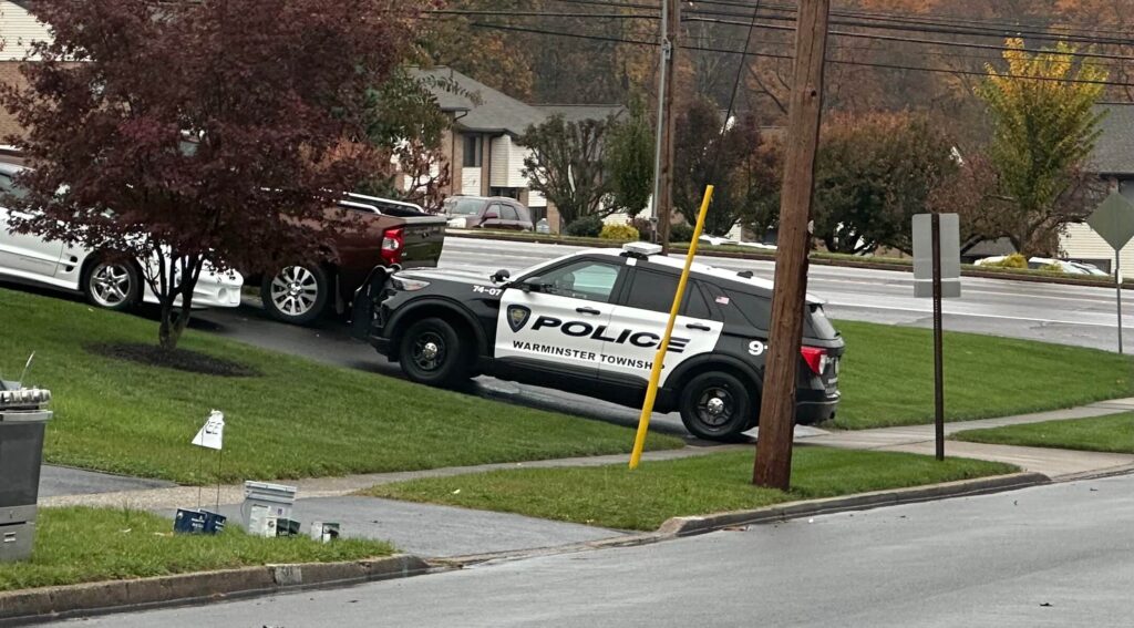 Police car parked in front of residential home during a burglary investigation in Warminster, PA