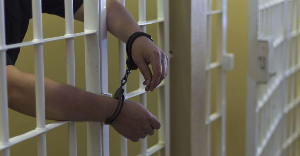 Prisoner in a jail cell after the police arrest him for a sex crime