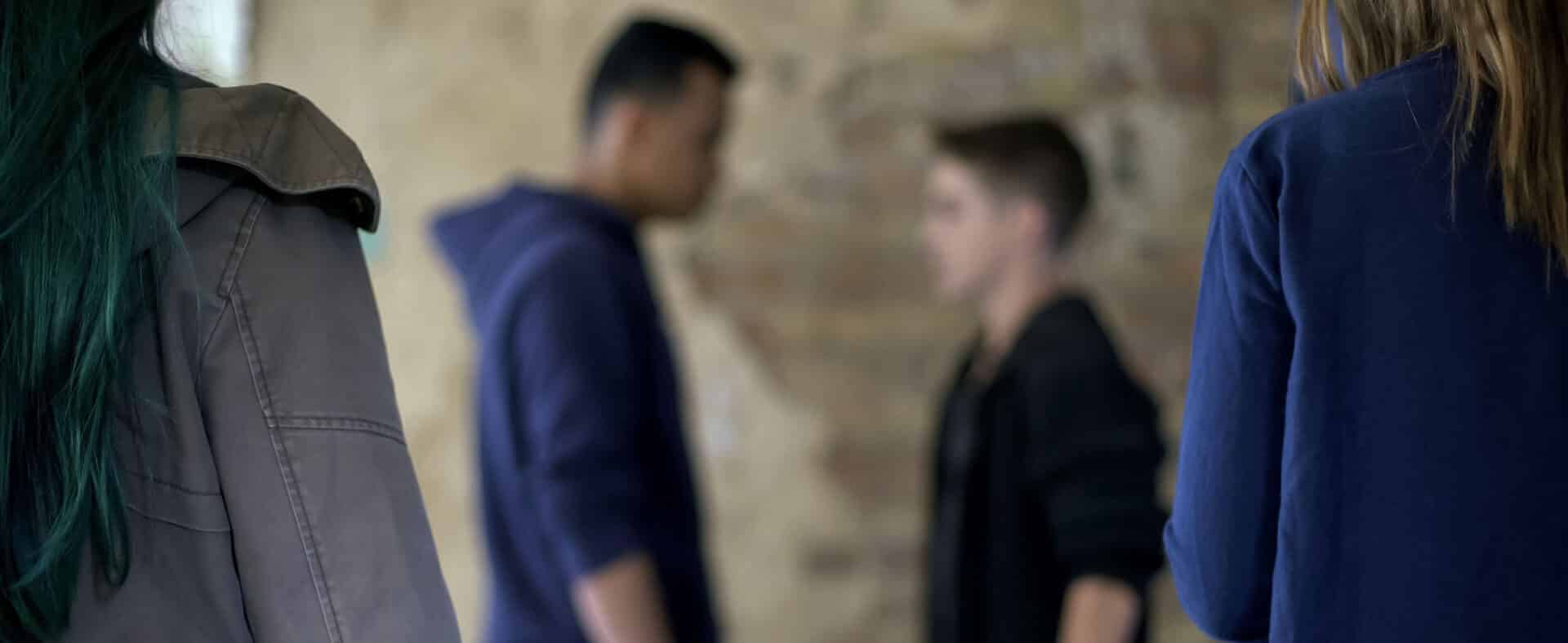 One teenager making a terroristic threat against another teenager face to face during an argument.