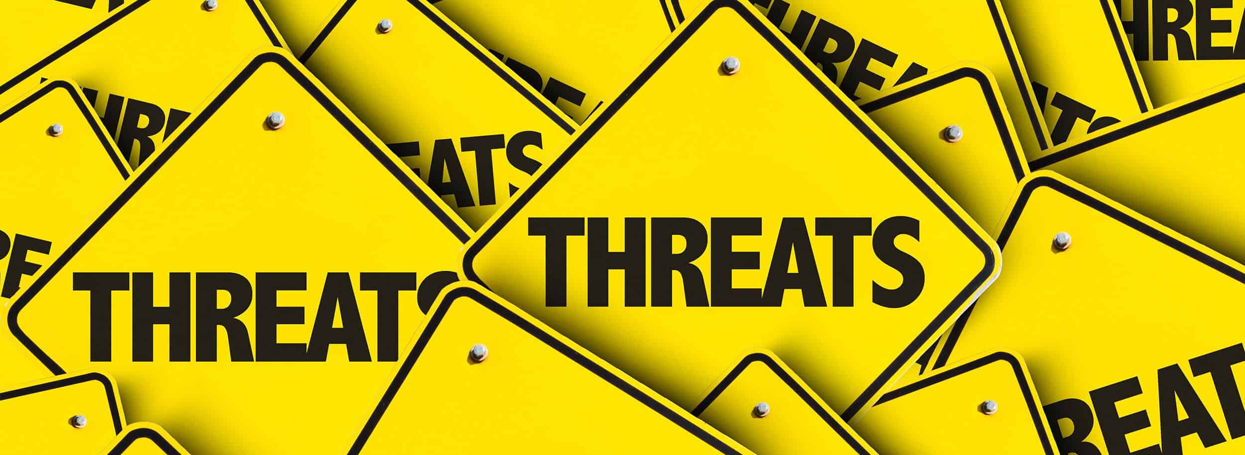 The word "threats" written on signs.